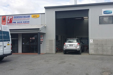 Car panel beaters repairing vehicle body damage in Upper Hutt